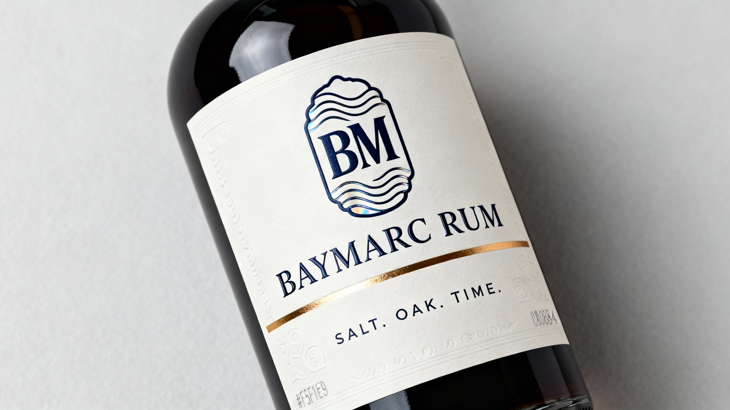 Baymarc Rum bottle concept with navy label and gold detailing